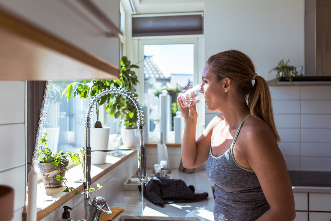Woman drinking clean filtered reverse osmosis water