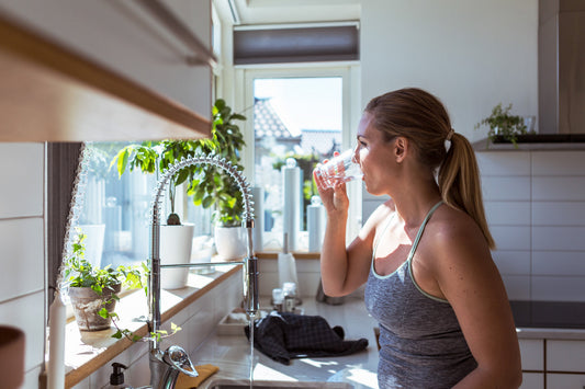 Woman drinking clean filtered reverse osmosis water
